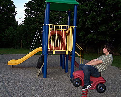 Kevin plays on the spring car in the Prospect Park playground