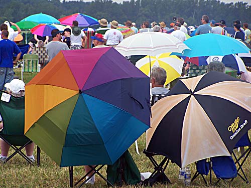 2008 Geneseo Airshow - crowds along the runway with umbrellas protecting against the sun and the rain