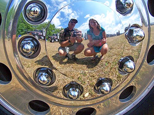 Show and shine, reflection in big rig hubcap