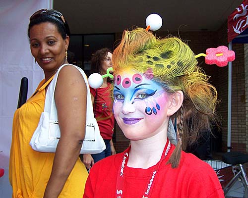 A girl models her face painting courtesy of Kromatik