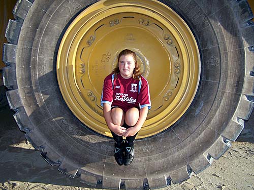 Erin in the big cat dump truck tire