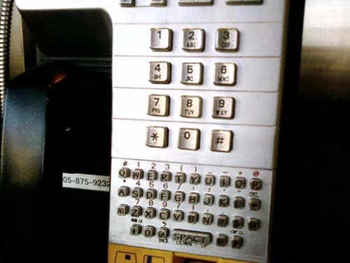 A bell pay phone with a keyboard for texting