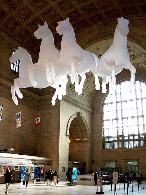 Luminato art festival in Toronto. Installation of four floating horses suspended from ceiling of Union Station by artist Max Steicher, title "Quadriga".