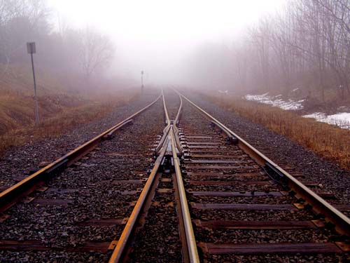 Train tracks run into the distance on a foggy day in Acton, Ontario